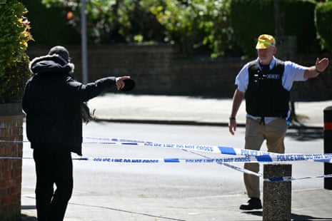 A local resident (L) speaks to a member of a local security detail at a cordoned off area in the Golders Green neighbourhood of north London on April 29, 2026, following the stabbing to two people nearby.