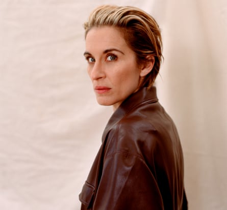 Actor Vicky McClure, in brown faux-leather jumpsuit, against pale background, November 2021