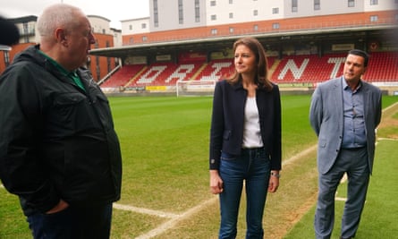 Lucy Frazer, the secretary of state for culture, media and sport, with the Leyton Orient chief executive, Mark Devlin (right), and Kevin Miles of the Football Supporters’ Association