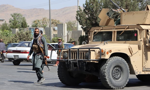 Taliban fighters block the road to Kabul airport