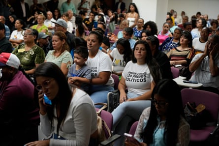 Room full of people, some wearing T-shirts that say Free All Political Prisoners