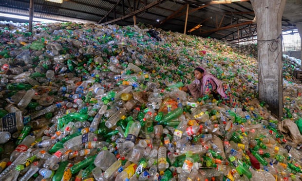 A worker sorts used plastic bottles in a recycling factory in Dhaka, Bangladesh.