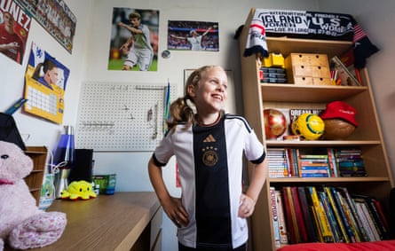 England’s united nations of football: 32 teams, one World Cup – and a lot of excited kids | World Cup 2022 17 Rebecca Eichler wearing a Germanyshirt and standing in a room decorated with footballs, scarves and posters