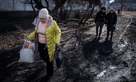 A woman leaves her house in the village of Minkivka, north of Bakhmut.