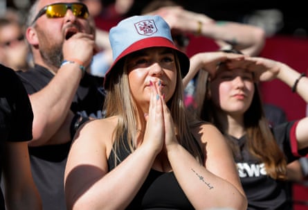 A West Ham fan with claret and blue hat and nails prays in the second half against Everton on April 25th 2026
