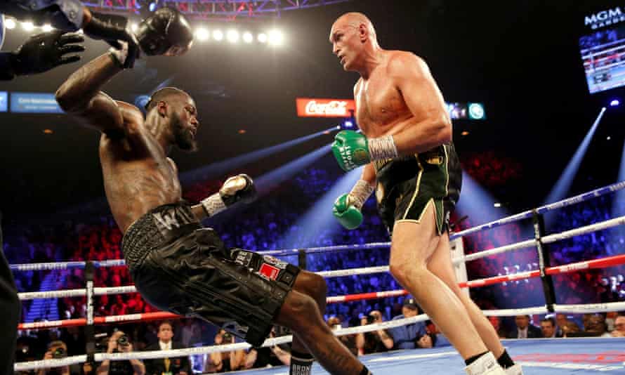 Tyson Fury knocks Deontay Wilder down