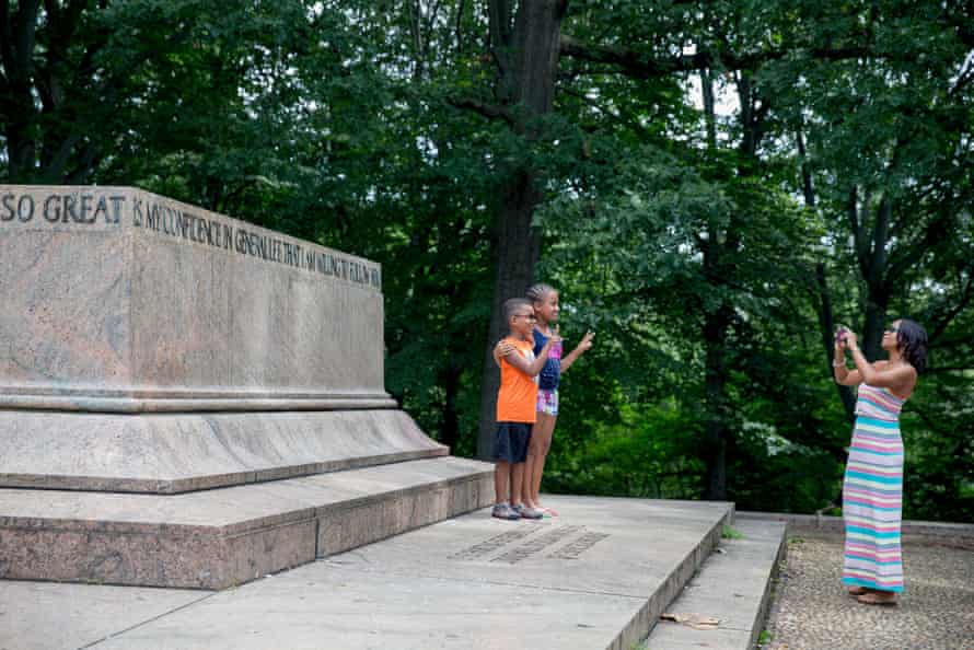 A family takes photos at the Robert E. Lee and Thomas J. “Stonewall” Jackson monument base in Wyman Park Dell in Baltimore, Maryland, after it was removed by the city on August 16, 2017. Confederate statues were removed overnight in Baltimore, Maryland, as a campaign to erase symbols of the pro-slavery Civil War South gathers momentum across the United States. The removal of the Baltimore monuments came four days after clashes in Charlottesville, Virginia that stemmed from a rally called by white supremacists to protest plans to remove a statue of Lee from a public park.