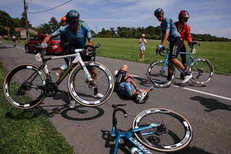 Mark Cavendish lies on the tarmac after crashing out of the race.
