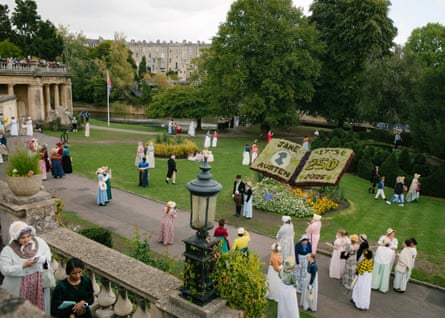 People in period costume wander around Bath’s Parade Gardens