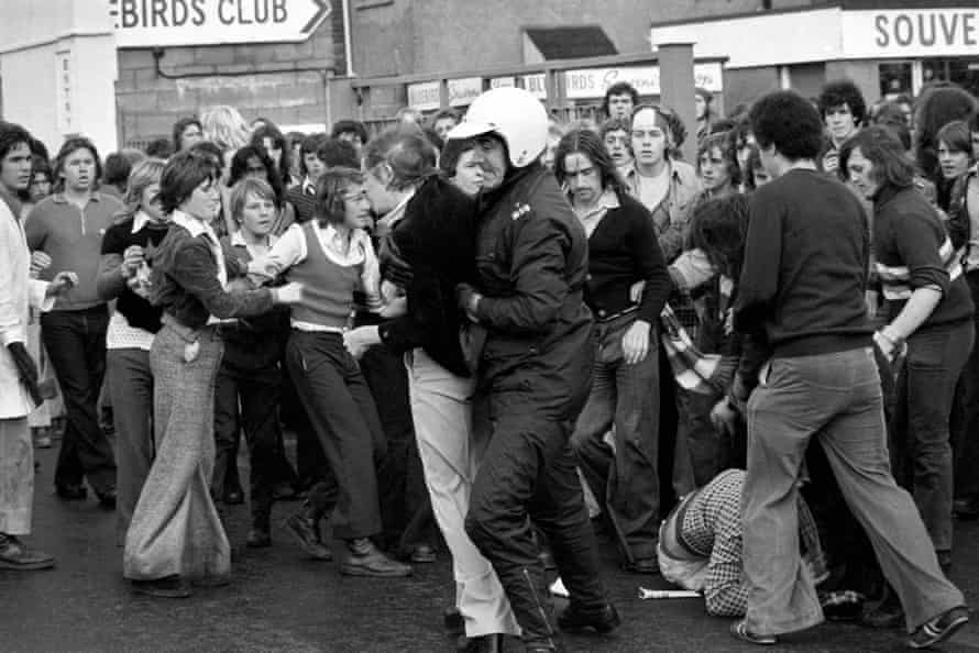 A fan is arrested during a fight outside Ninian Park before the Cardiff v Manchester United game in 1974.