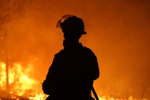 A firefighter defends a property near Potato Point on NSW South Coast on Thursday 23 January 2020.