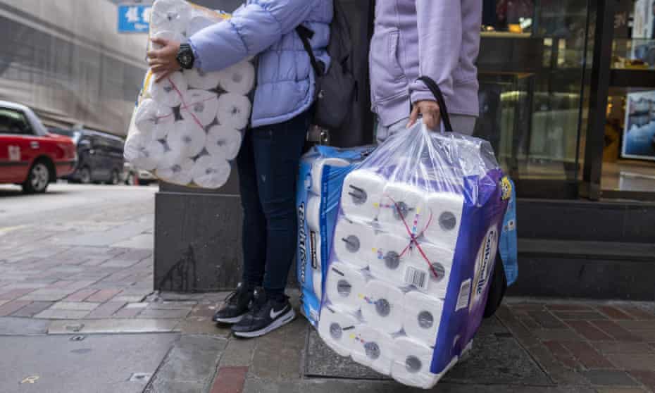People carry bags of newly purchased toilet paper in Hong Kong, China.
