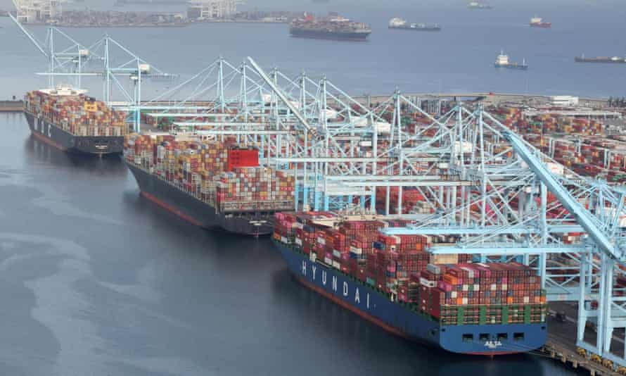 Shipping containers are unloaded from ships at a container terminal at the Long Beach-Los Angeles port complex in California