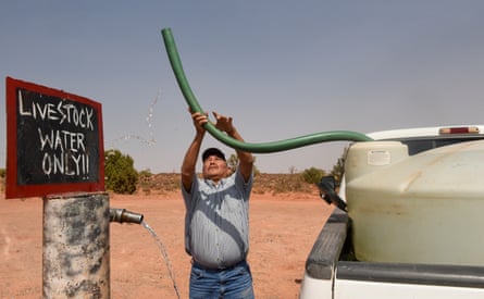 A livestock farmer in Arizona fills up a water tank for his animals to drink from last month. Once upon a time, rain water would have been sufficient.
