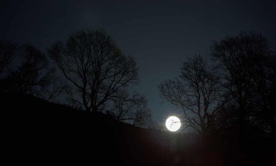 A full moon rising over Ambleside, Lake District, 7 April 2020