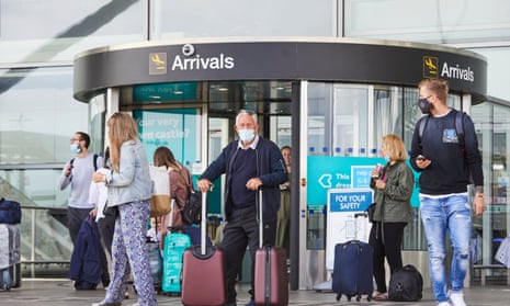 Passengers arrive at London Stansted airport, owned by Manchester Airports Group.