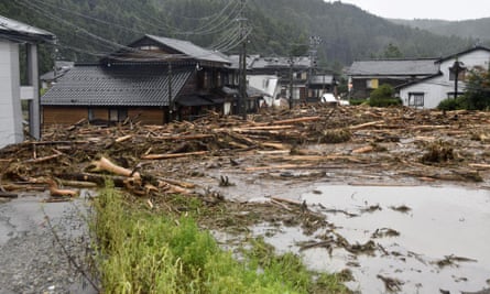 Ruined houses amid debris and water.