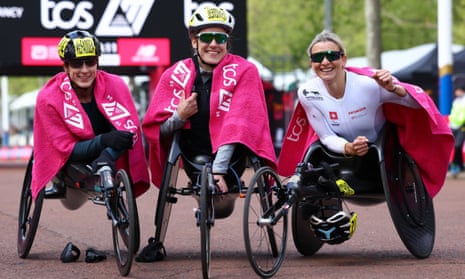 Catherine Debrunner celebrates after winning the elite women's wheelchair race along with second placed Switzerland's Manuela Schar and third placed Tatyana McFadden