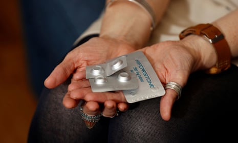 A pro-choice activist holding some abortion medication