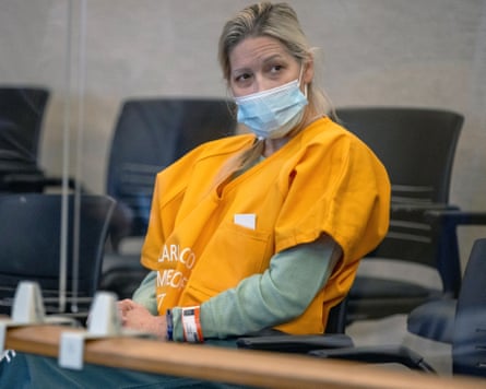 Shannon O’Connor in a courtroom, wearing a face mask and orange jumpsuit