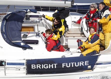 The couple and other crew members on Bright Future. They are wearing red and yellow waterproof jackets and trousers.