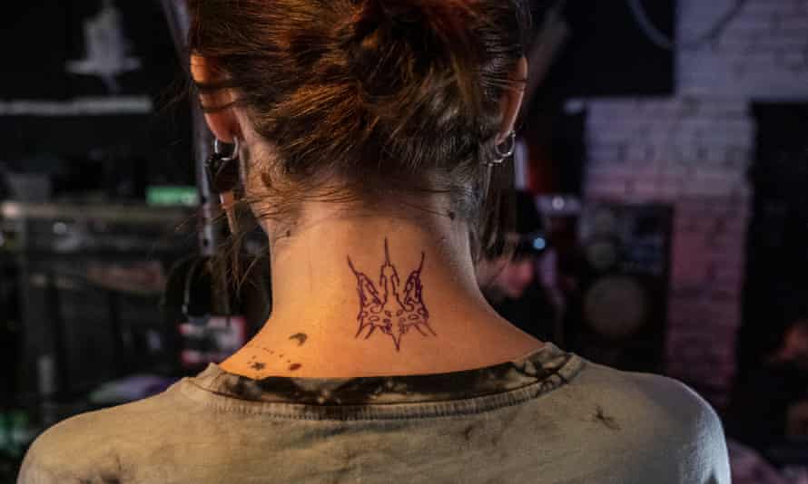 A stylised Ukraine coat of arms tattooed on the neck of a girl in Kyiv