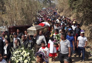 Family members carry the caskets of two boys who were kidnapped and killed on February 14, 2017 in San Juan Sacatepequez, Guatemala. More than 2,000 people walked in a funeral procession for Carlos Daniel Xiqin, 10, and Oscar Armando Top Cotzajay, 11, who were reported abducted walking to school Friday morning. Residents found the boys stuffed in sacks over the weekend, with the boys’ throats slashed and hands and feet bound. Neighbors reported a ransom demand was made. Such crimes have driven emigration from Guatemala to the United States, as families seek refuge from the violence