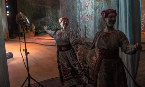 Actors in traditional Ukrainian clothing leave the stage during an opera in Kyiv amid the war