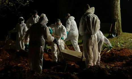 TOPSHOT-BRAZIL-HEALTH-VIRUS<br>TOPSHOT - A coffin is buried at the Vila Formosa cemetery in Sao Paulo, Brazil, on March 31, 2021, amid the novel coronavirus COVID-19 pandemic. - Brazil closed out its deadliest month of the coronavirus pandemic by far on Wednesday as a surge of COVID-19 patients overwhelmed hospitals, forcing doctors to make agonizing decisions over whom to give life-saving care. (Photo by Miguel SCHINCARIOL / AFP) (Photo by MIGUEL SCHINCARIOL/AFP via Getty Images)