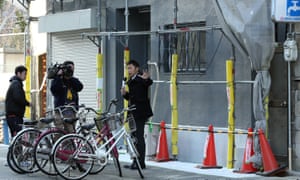 A local TV crew reports from in front of the lodging facility where the severed head of a woman was found in Osaka, Japan.