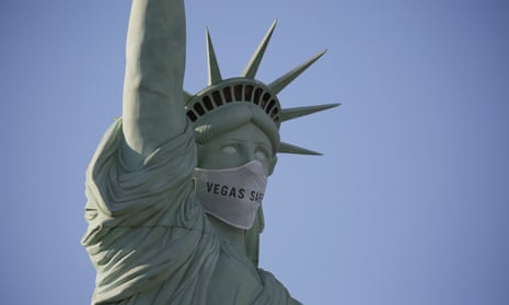 A mask adorns the face of a Statue of Liberty replica in Las Vegas.