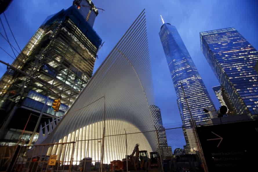 The Oculus at night with One World Trade Center next to it.
