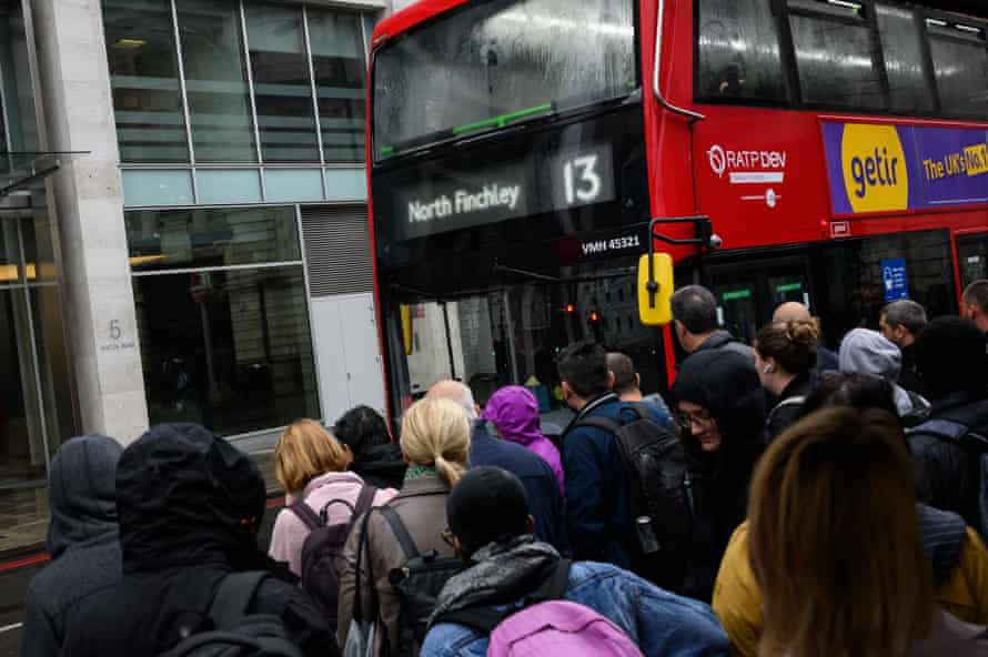 Commuters queue to board packed buses at Victoria Station as a tube strike impacts the Monday morning rush hour today.