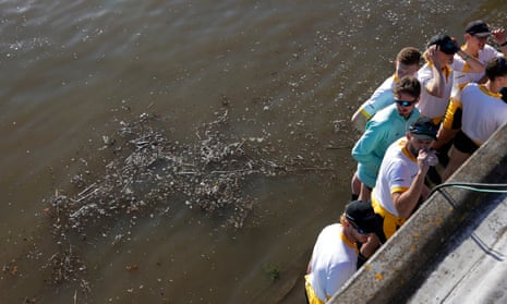 Cambridge’s winning crews stand by dirty water at the finish of this year’s Boat Race on the Thames.