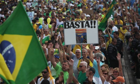Demonstrators hold up a sign reading ‘enough’ at a rally in Rio de Janeiro against the Petrobras corruption scandal. 