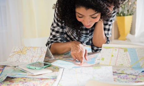 Woman planning road trip with maps