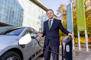 Grant Shapps modelling one of the new designs of electric vehicle charger.