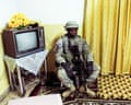 Sergeant Jackson rests in a living room during a house search in Rawa, Iraq