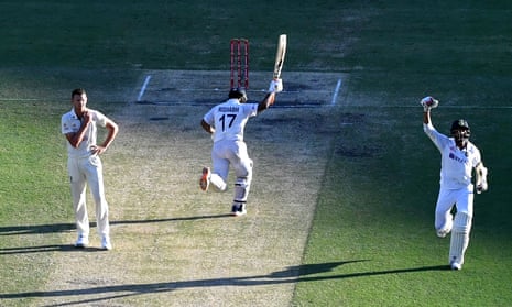 Rishabh Pant (centre) and Navdeep Saini of India celebrate India’s remarkable Test series win as they run past Australia’s Josh Hazlewood.