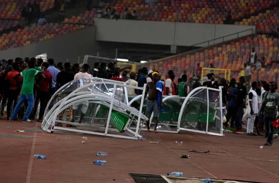 Angry Nigeria fans break the benches following their exit at the hands of Ghana in Abuja.