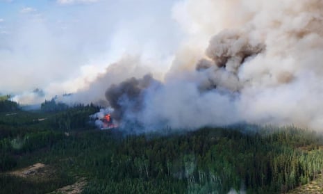  Smoke rises above the southeast perimeter of the Paskwa fire as it burns near Fox Lake, Alberta, Canada.