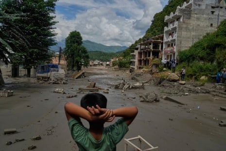 A boy looks at the devastation caused by flash flooding along the Trishuli River in Nepal's Nuwakot district.