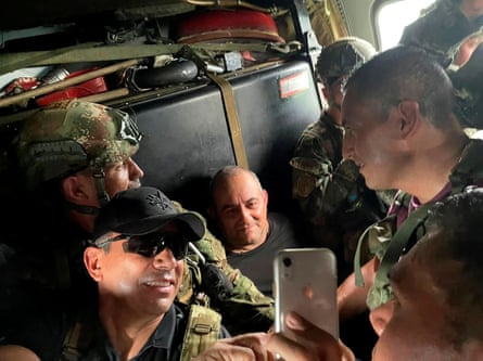 Otoniel poses for a photo while escorted by Colombian military soldiers inside a helicopter after being captured in Turbo, Colombia.