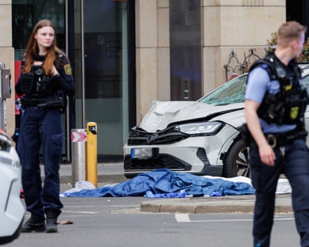 An SUV with a damaged bonnet and a shattered windscreen at the scene