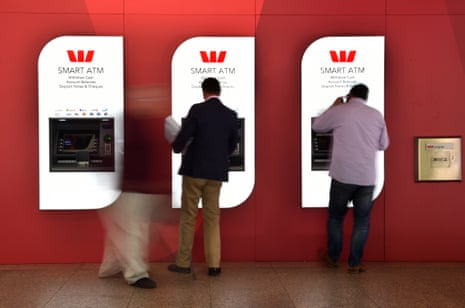 Customers standing at Westpac ATMs.