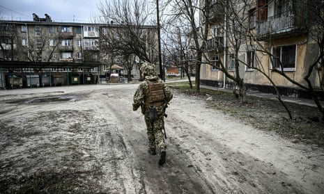 A Ukraine army soldier walks along an icy road