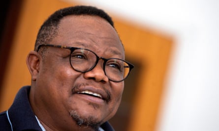 Tundu Lissu close-up, wearing glasses, smiling.