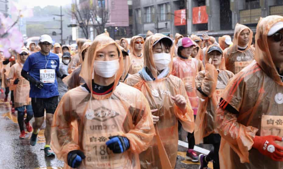 Runners, some wearing masks, compete on Sunday in a marathon in Kumamoto city, western Japan.
