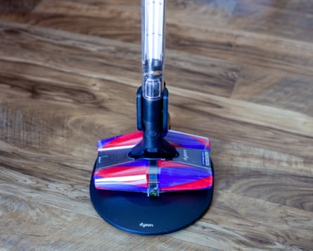 A Dyson PencilVac Fluffycones on a charging base