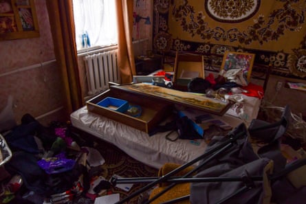 Ransacked bedroom with draws emptied and items strewn across room.